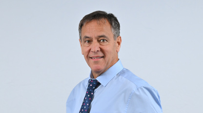 Portrait photo of Cormac McKervey - white male with short grey/ dark hair and brown eyes